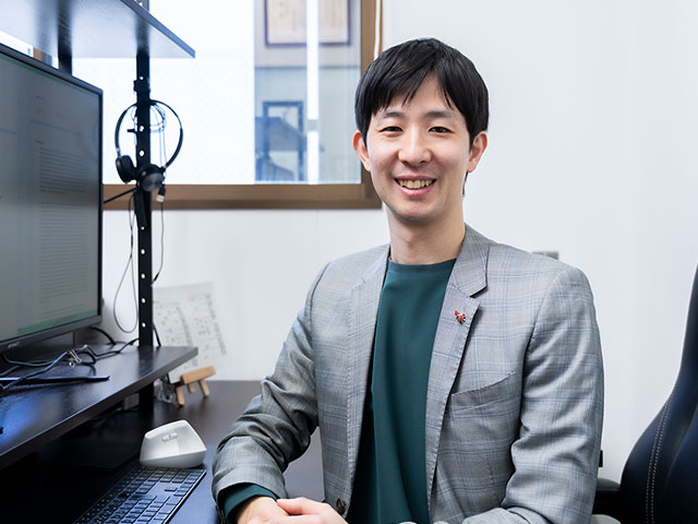 研究室パソコン前に座る研究者