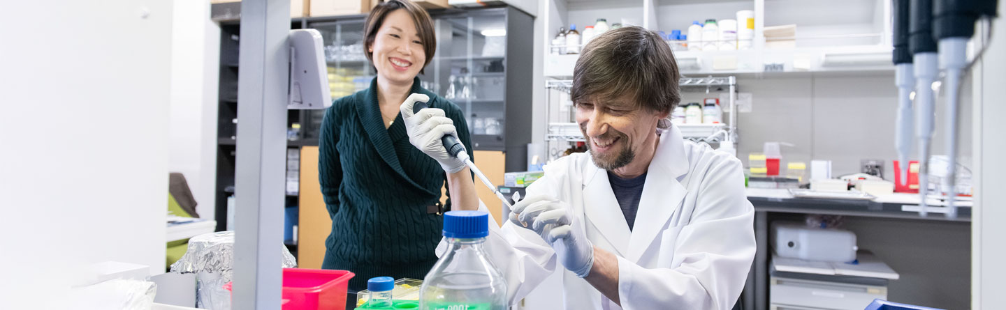 researchers working at the bench inside a lab